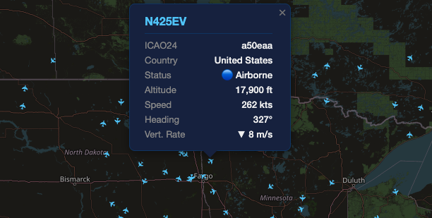 Close-up of the map near Fargo, North Dakota with an aircraft popup open for N425EV, listing ICAO24 a50eaa, country United States, status Airborne, altitude 17,900 ft, speed 262 kts, heading 327 degrees, and vertical rate 8 meters per second descending.